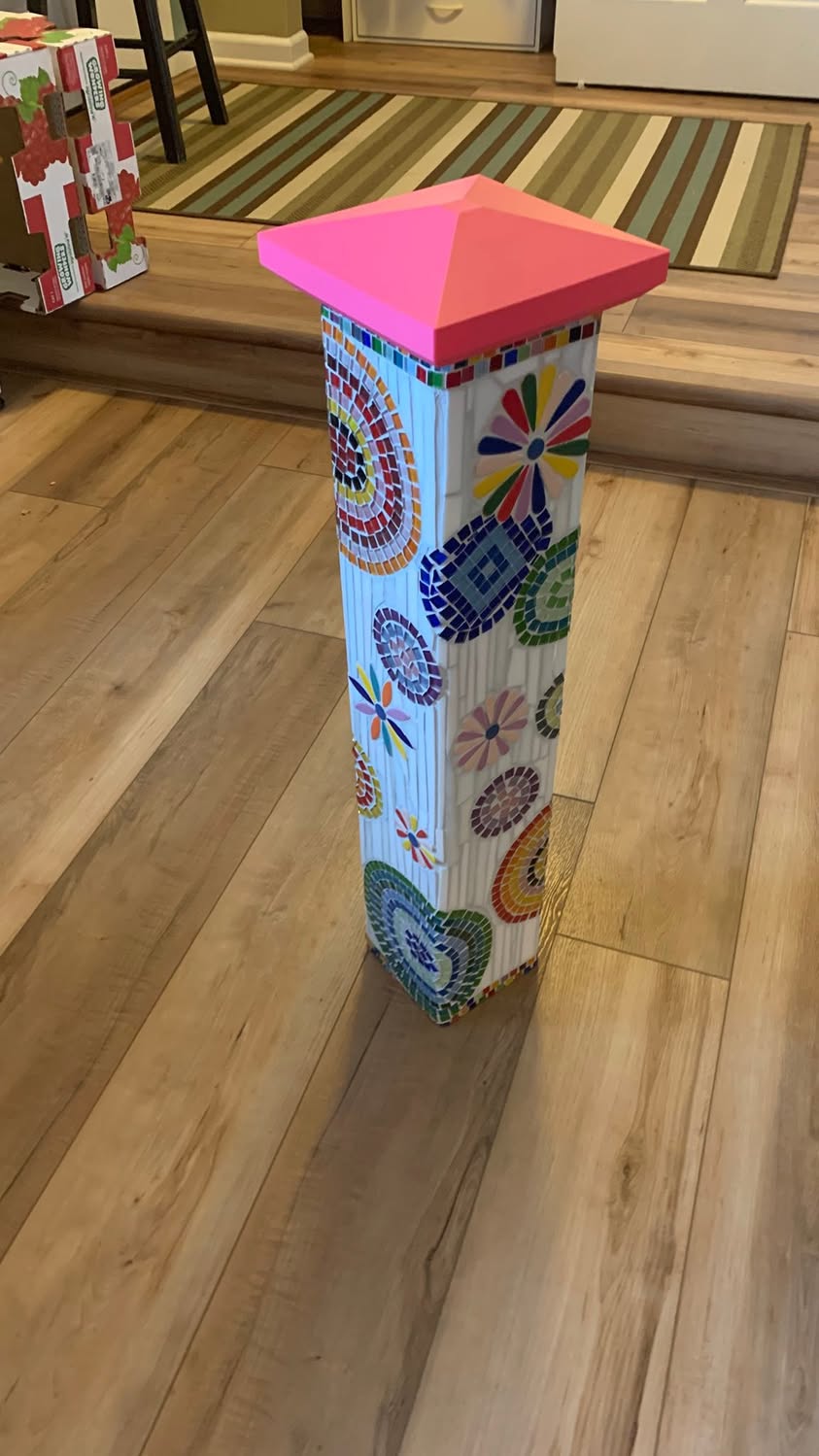 Another view of a colorful mosaic-covered column with a bright pink custom cap.