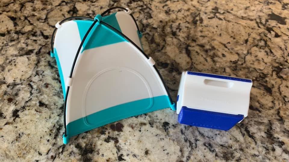 A miniature 3D-printed camping playset made for a doll, including a tiny tent and camping accessories.