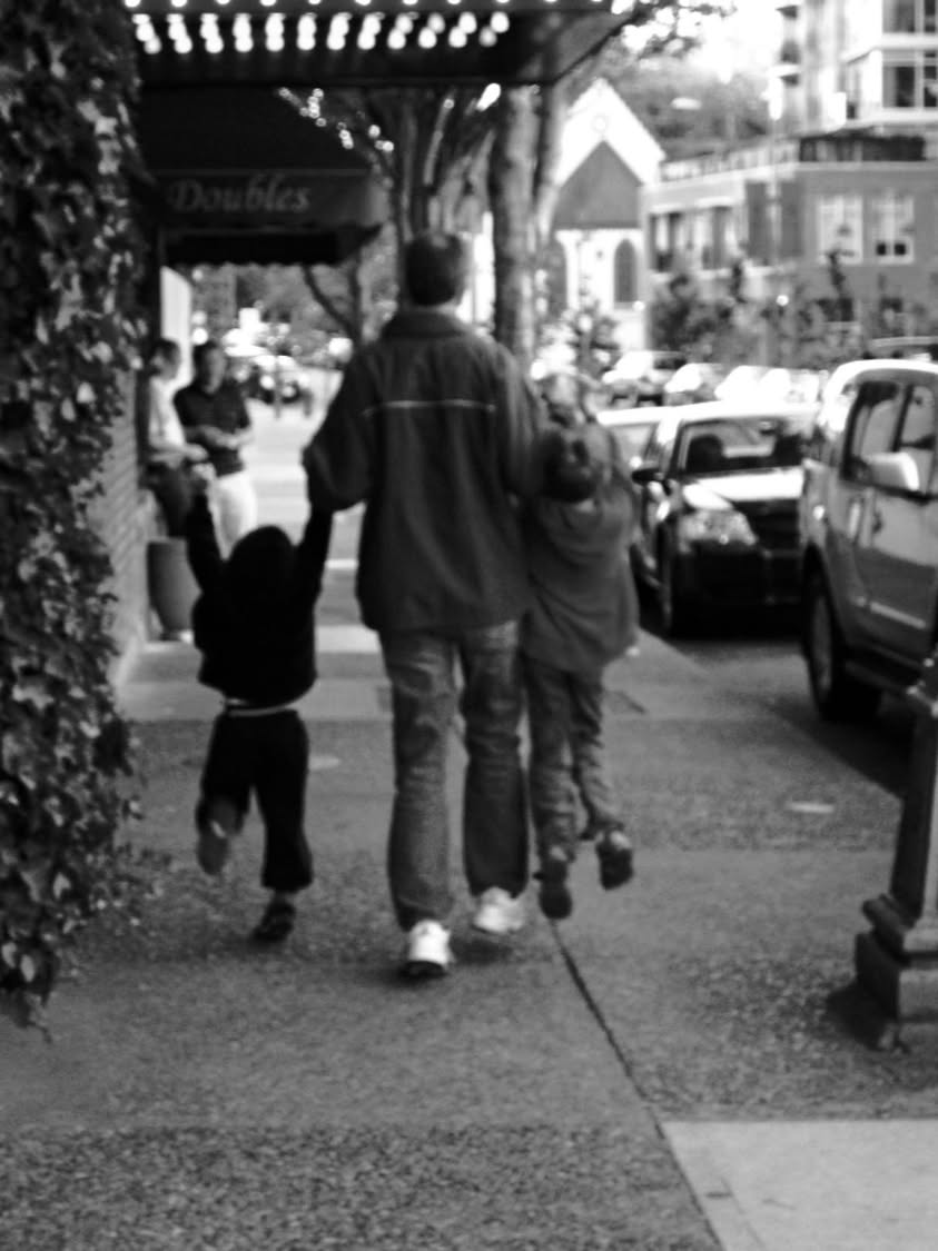A family travel photo taken from behind as the three boys walk ahead, with Mom in her usual caboose position.